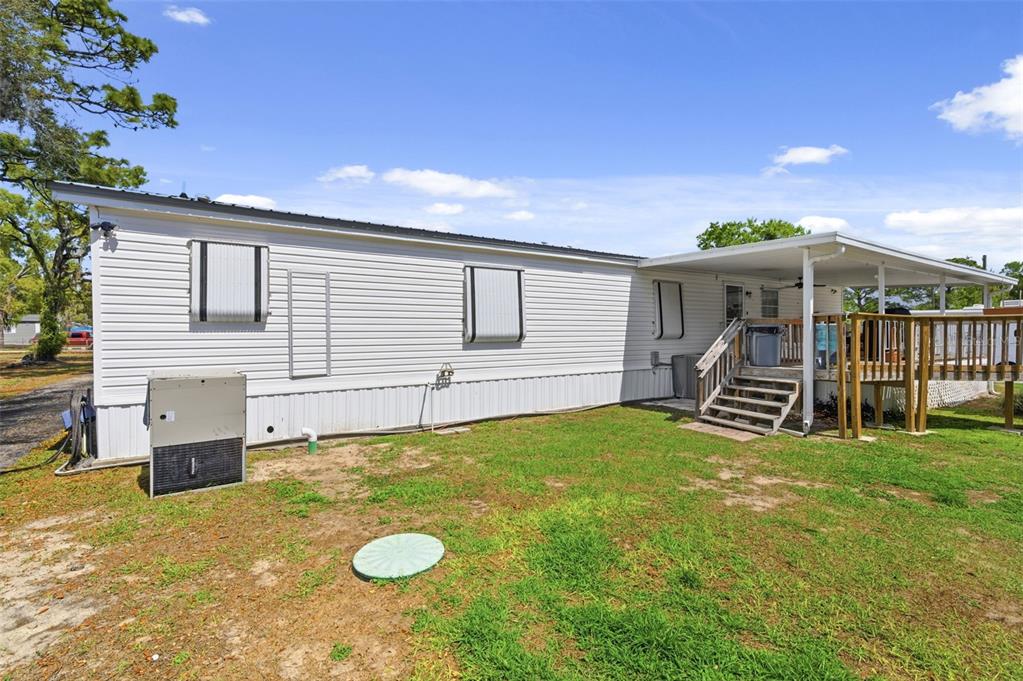 9634 Pat Street Hudson, FL 34669 - Photo 50 of 73 a view of a house with a backyard and a patio