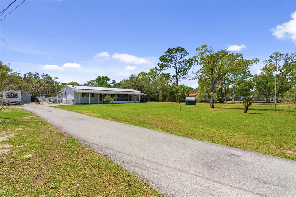 9634 Pat Street Hudson, FL 34669 - Photo 5 of 73 a view of a house with a big yard