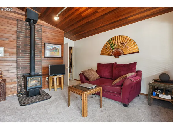 a kitchen with stainless steel appliances a stove a sink dishwasher and cabinets with wooden floor