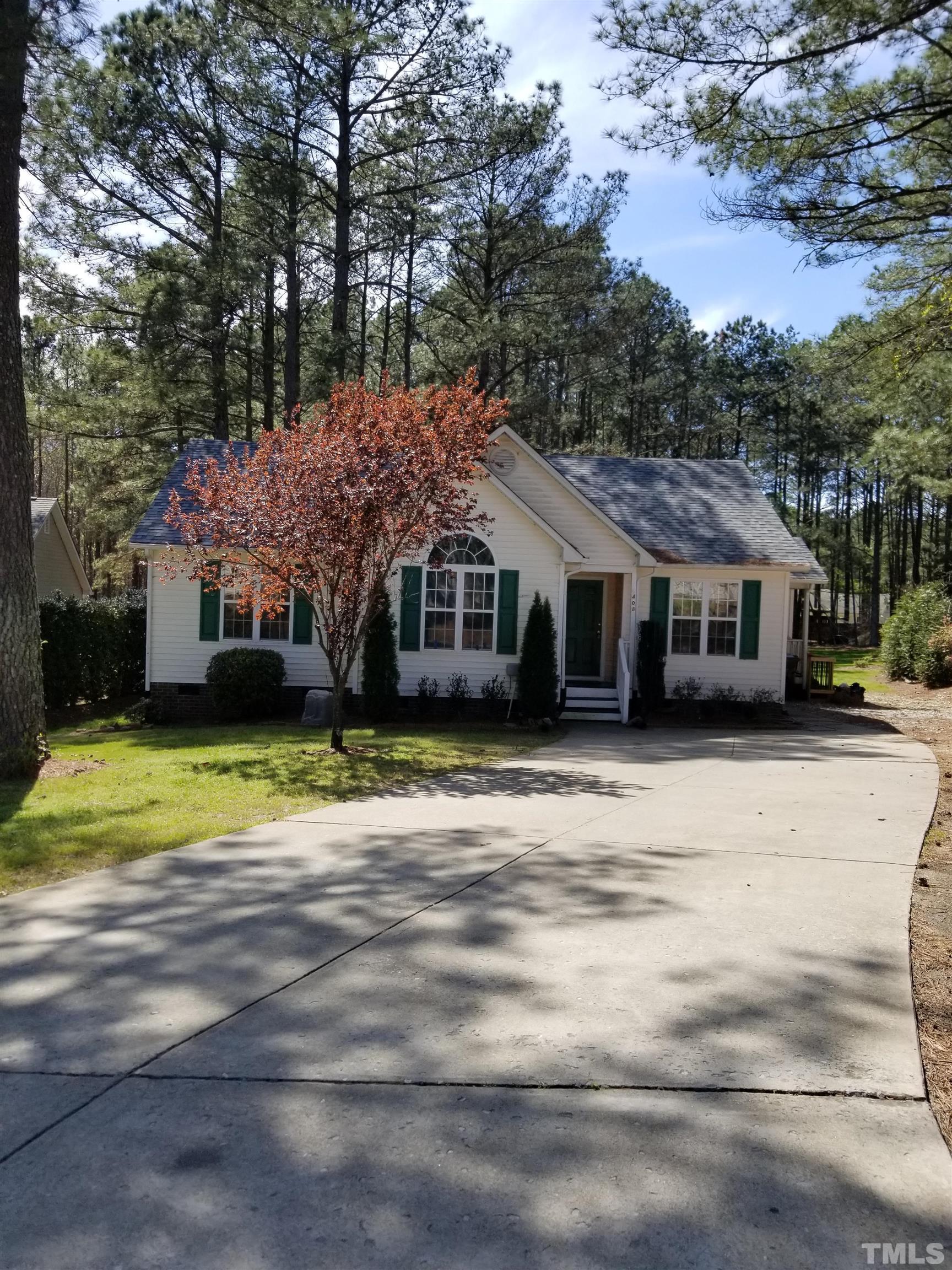 6408 Silver Spring Court Willow Spring, NC 27592 - Photo 1 of 11 a front view of a house with a garden