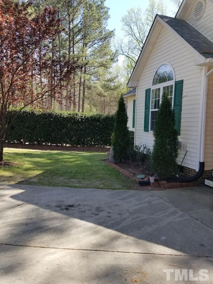 6408 Silver Spring Court Willow Spring, NC 27592 - Photo 11 of 11 a front view of a house with a yard