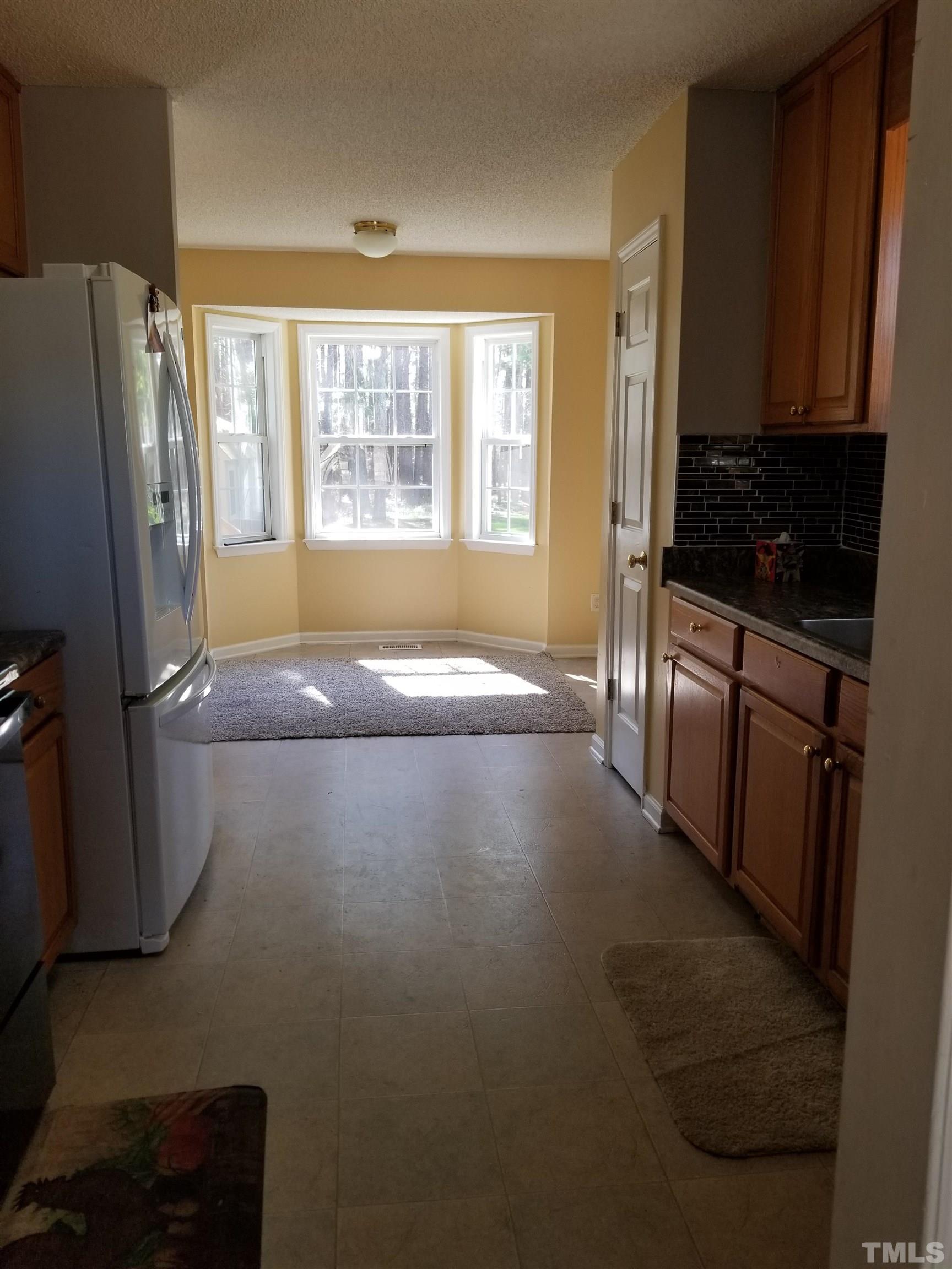 6408 Silver Spring Court Willow Spring, NC 27592 - Photo 9 of 11 a kitchen with stainless steel appliances a refrigerator stove and microwave