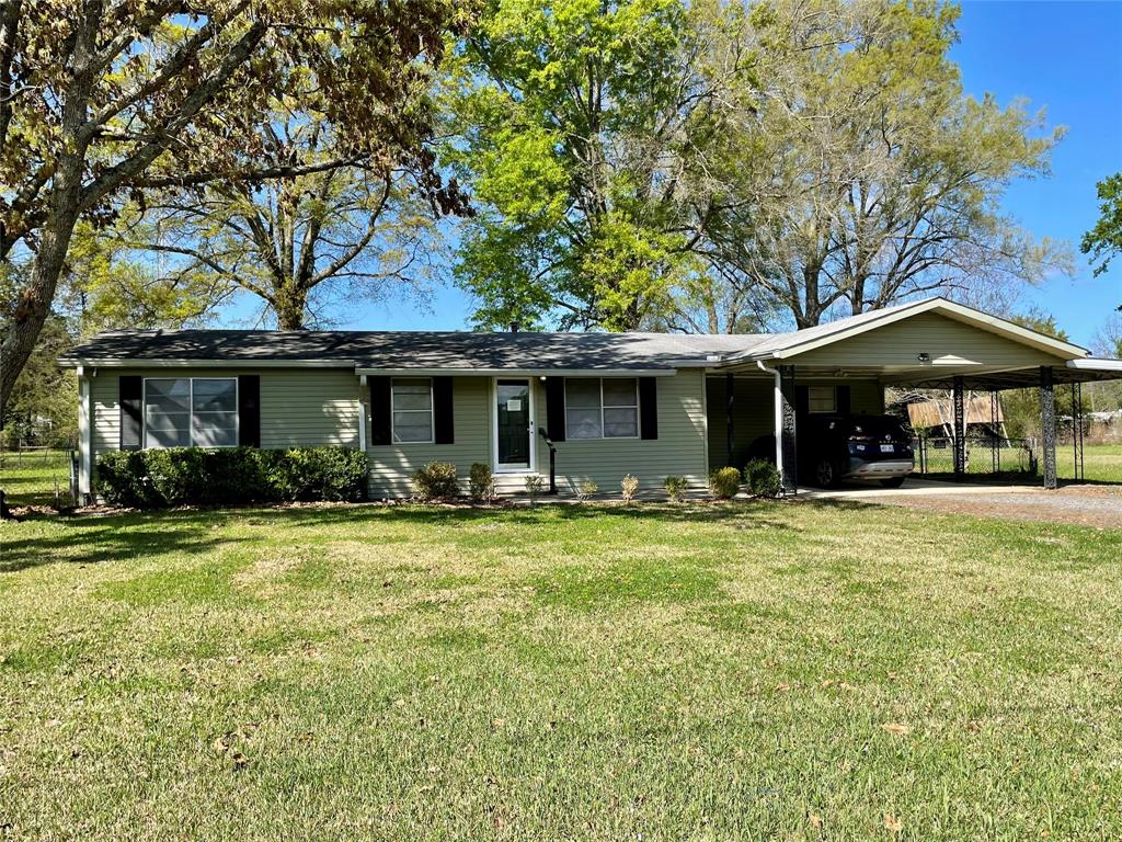 10806 Newson Road Keithville, LA 71047 - Photo 1 of 24 a front view of a house with a garden