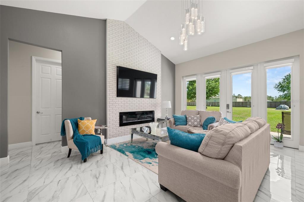 2009 Flower Terrace Sebring, FL 33875 - Photo 20 of 60 a living room with furniture a fireplace and a flat screen tv