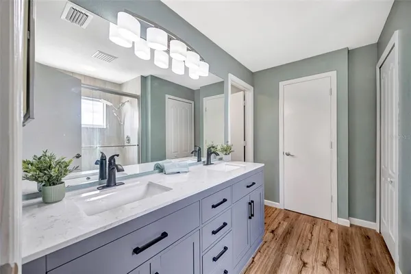 a bathroom with a sink double vanity and a mirror