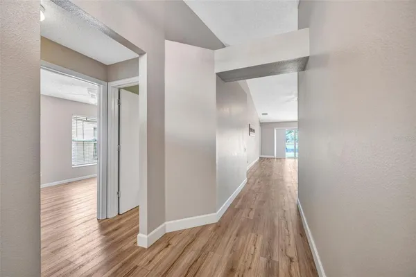 a view of a hallway with wooden floor