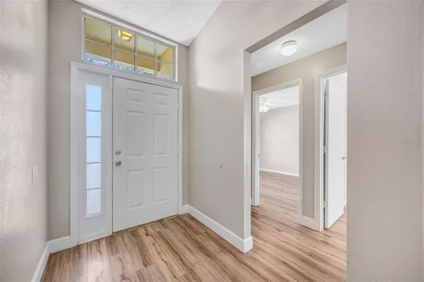 a view of a hallway with wooden floor and closet