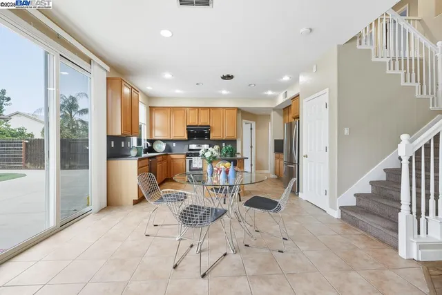 a kitchen with stainless steel appliances granite countertop a refrigerator and a stove top oven