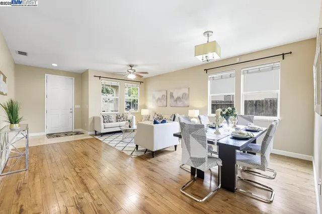 a living room with furniture a window and a table