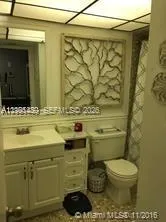 a bathroom with a sink toilet and mirror