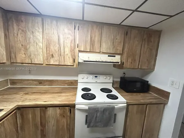 a kitchen with a sink a stove and refrigerator