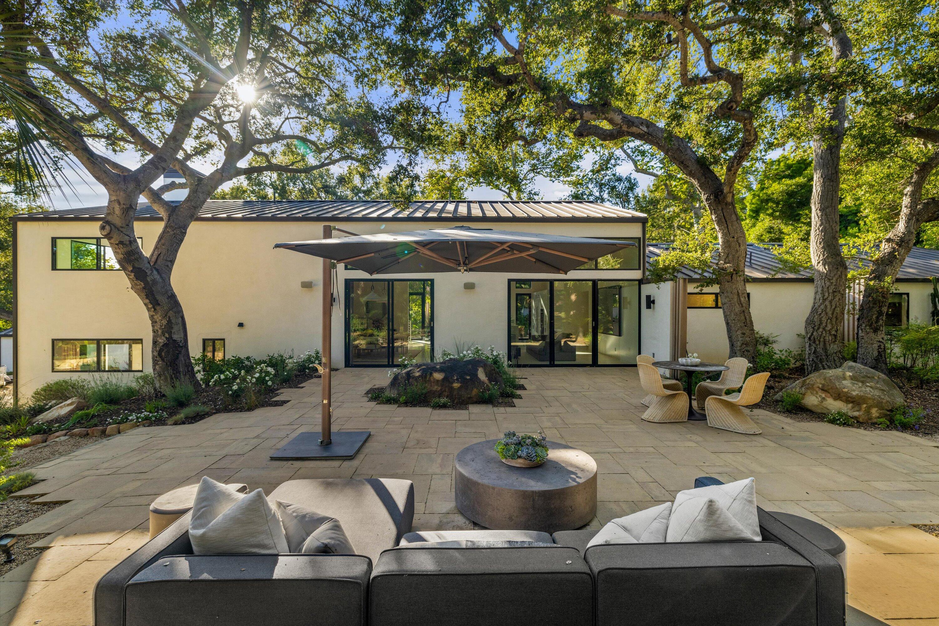 840 Riven Rock Road Montecito, CA 93108 - Photo 27 of 52 a view of a patio with couches table and chairs and potted plants
