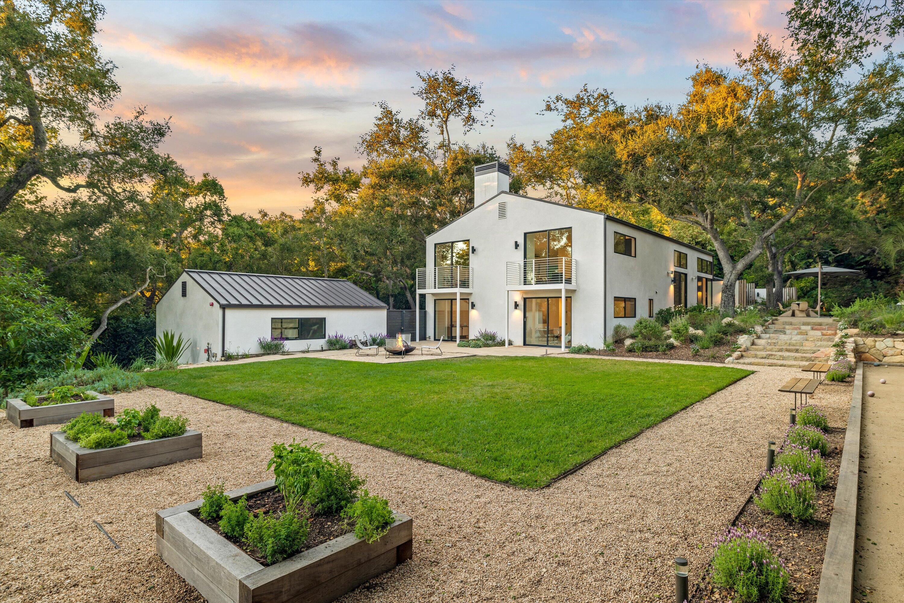 840 Riven Rock Road Montecito, CA 93108 - Photo 41 of 52 a view of a yard in front of a house with large windows