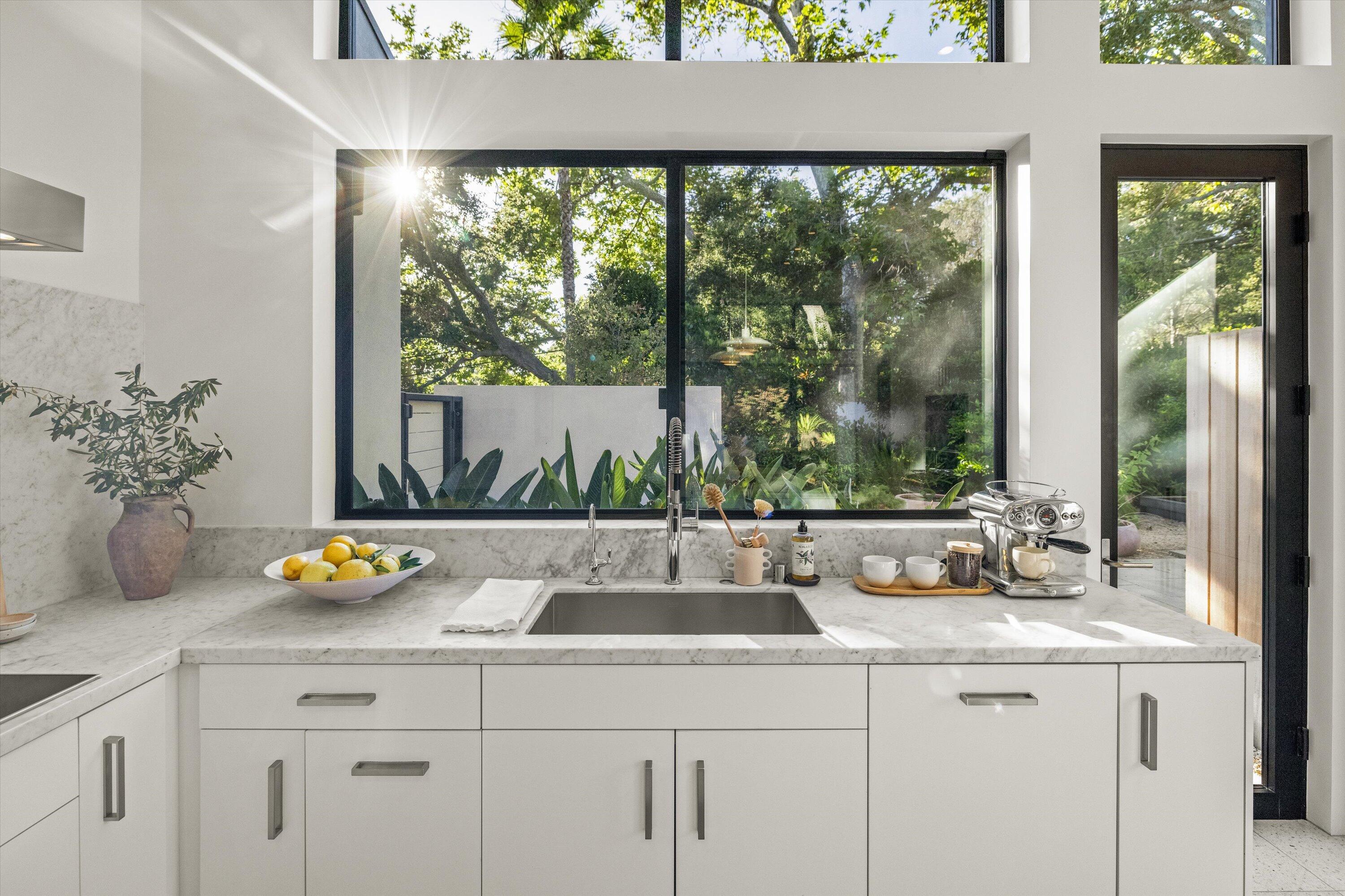 840 Riven Rock Road Montecito, CA 93108 - Photo 9 of 52 a kitchen with a sink and large window with garden view