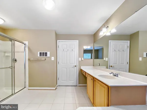 a spacious bathroom with a tub shower and sink