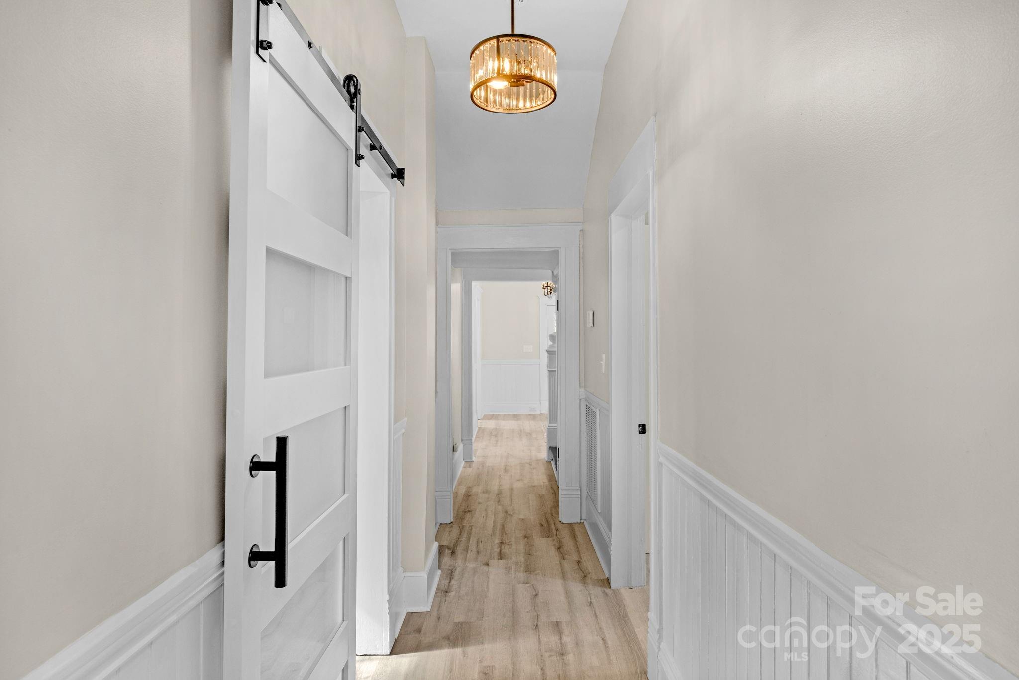 107 Rockingham Road Rockingham, NC 28379 - Photo 20 of 48 a view of a hallway with wooden floor and stairs