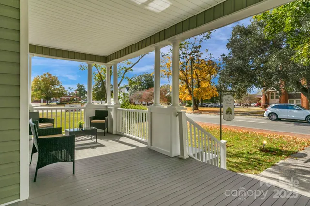 a view of a porch with furniture and floor to ceiling window