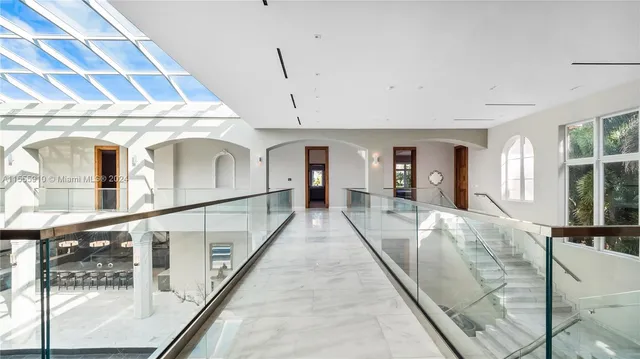 a living room with furniture and large windows