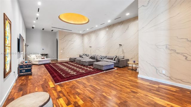 a view of a patio with table and chairs potted plants and large tree