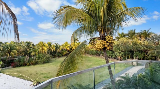 a view of a backyard with wooden fence