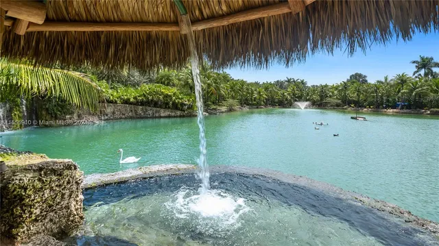 an aerial view of house with swimming pool outdoor seating and yard