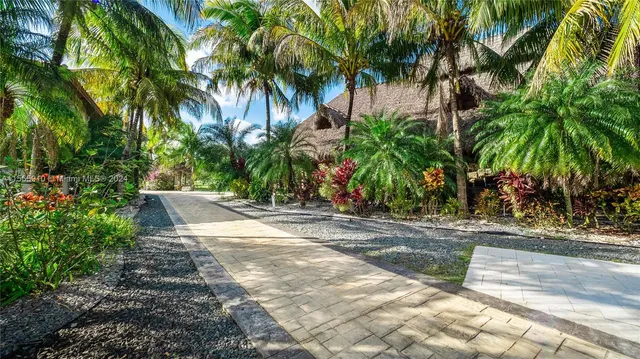 an aerial view of a house with garden space and street view