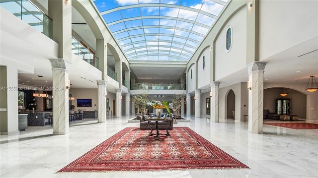 a large kitchen with granite countertop lots of counter space and stainless steel appliances