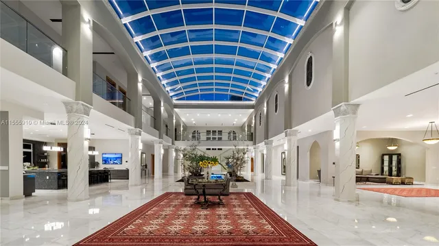 a living room with furniture fireplace and a large window