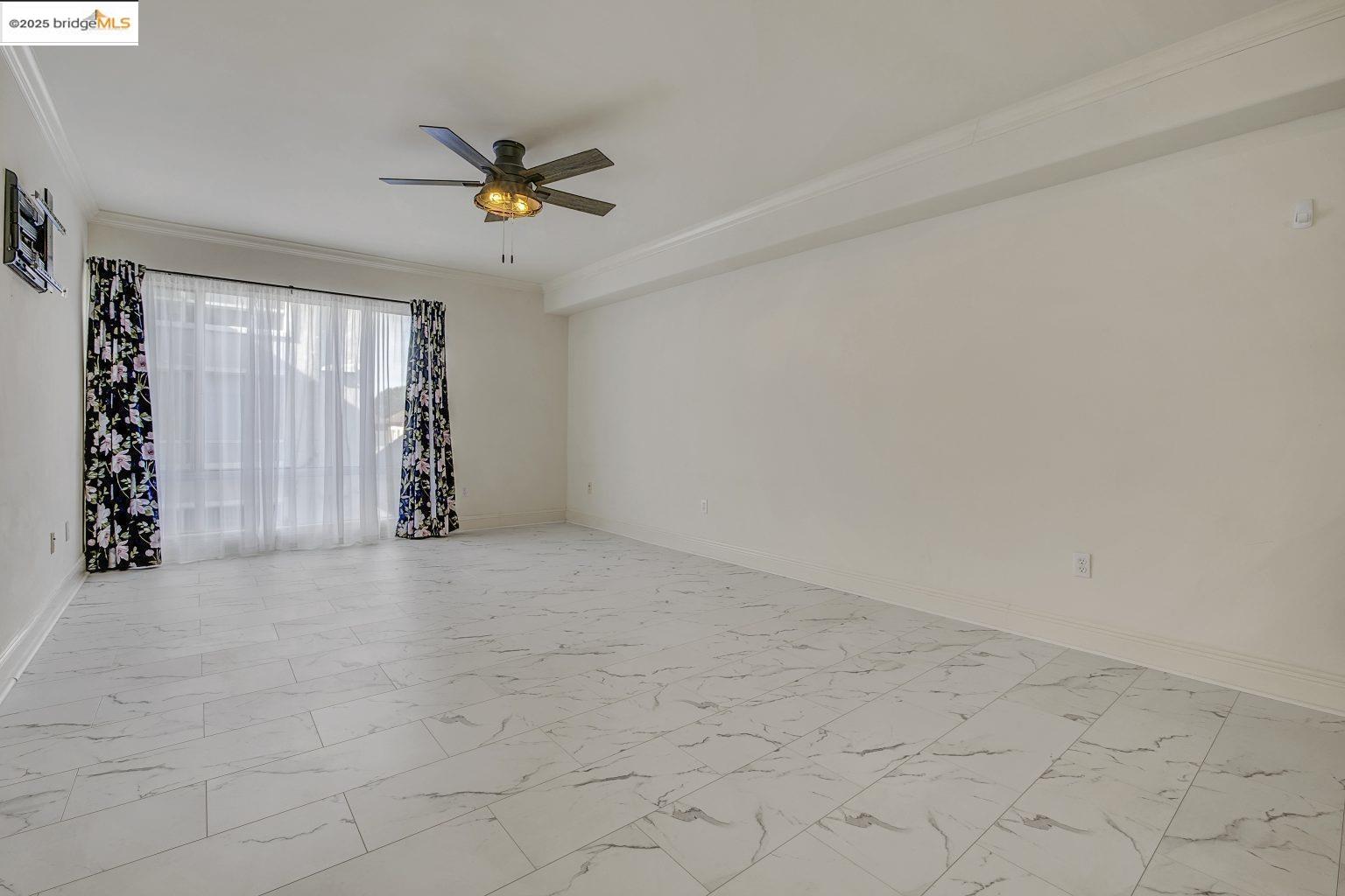 1515 14th Avenue, Unit 302 Oakland, CA 94606 - Photo 11 of 32 a view of a livingroom with a ceiling fan and window