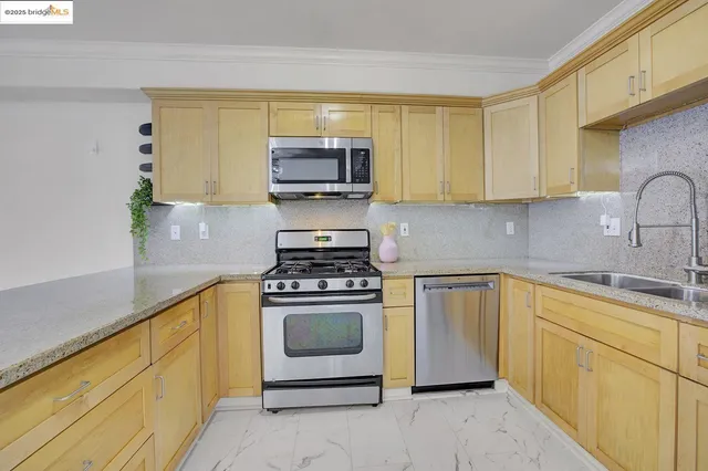 a view of a kitchen with an oven and cabinets