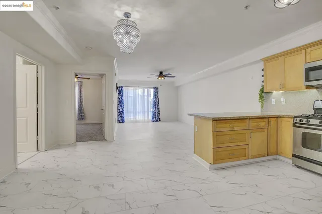 a view of a kitchen with refrigerator and windows