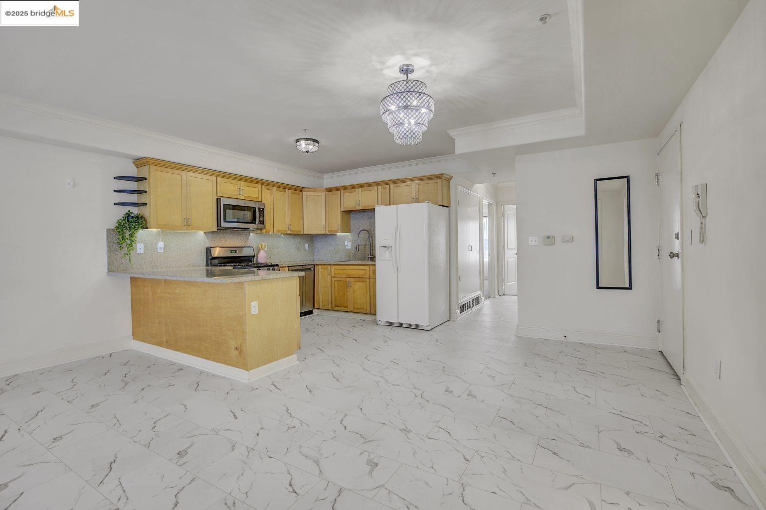 1515 14th Avenue, Unit 302 Oakland, CA 94606 - Photo 17 of 32 a view of a kitchen with refrigerator and windows