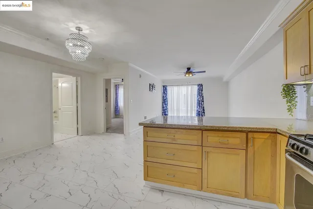 a kitchen with a refrigerator a stove a sink a counter top space and cabinets