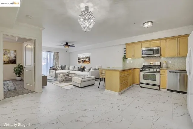 a living room with furniture and kitchen view