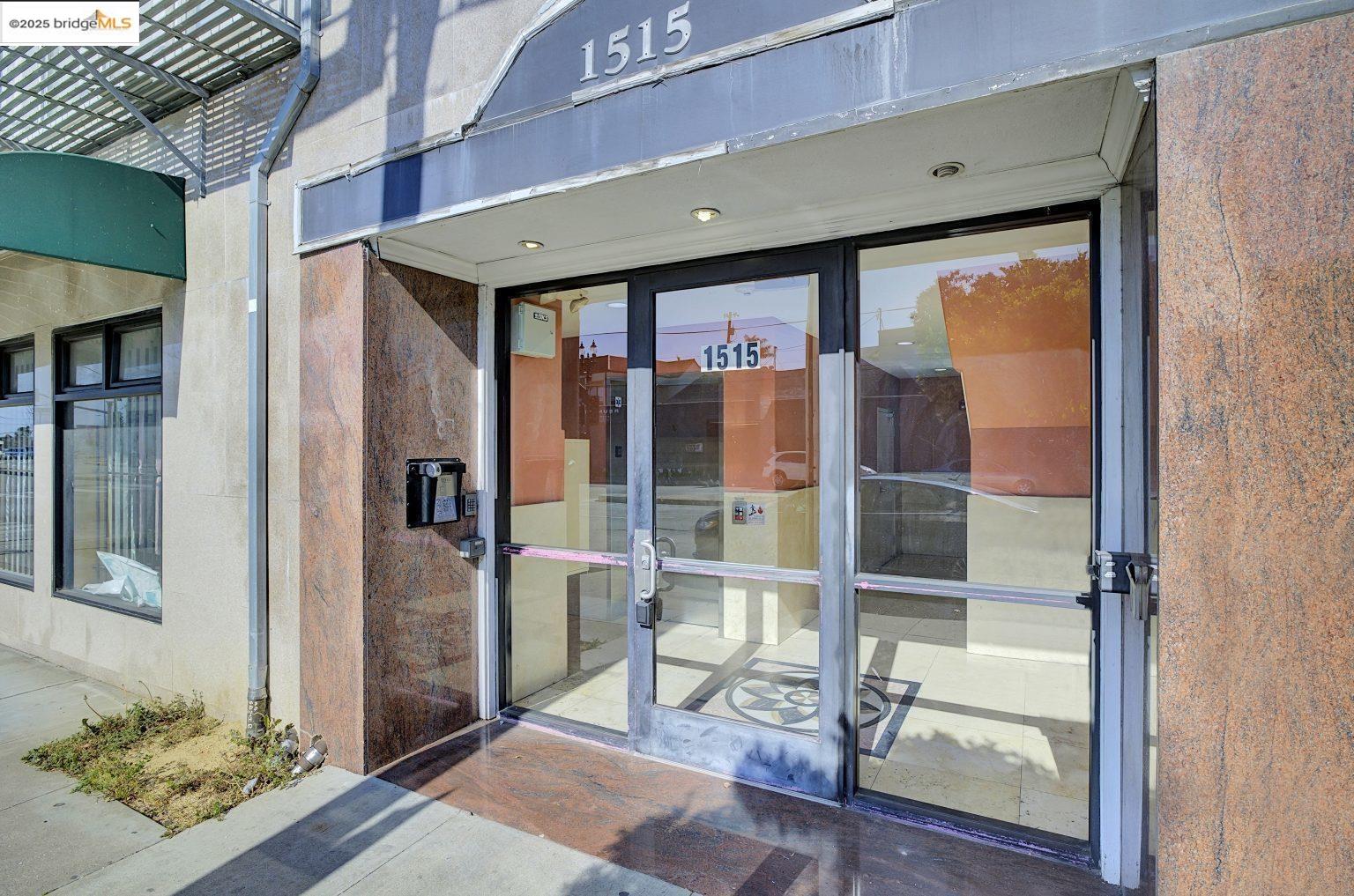 1515 14th Avenue, Unit 302 Oakland, CA 94606 - Photo 31 of 32 a front view of a building with a glass door