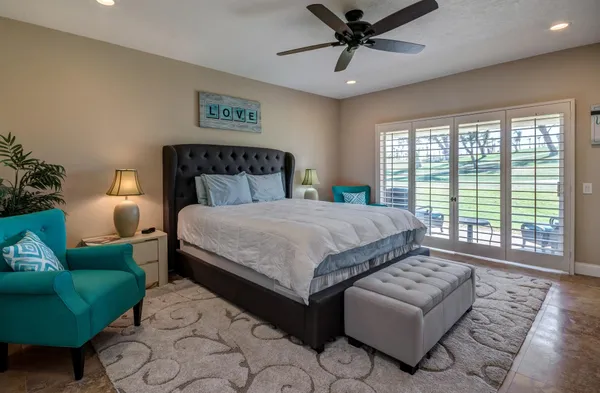 a spacious bedroom with a bed and a view of bathroom