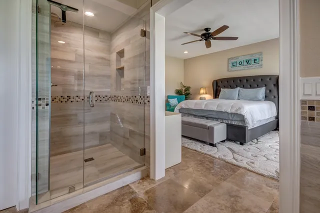 a spacious bathroom with a glass shower door and a sink