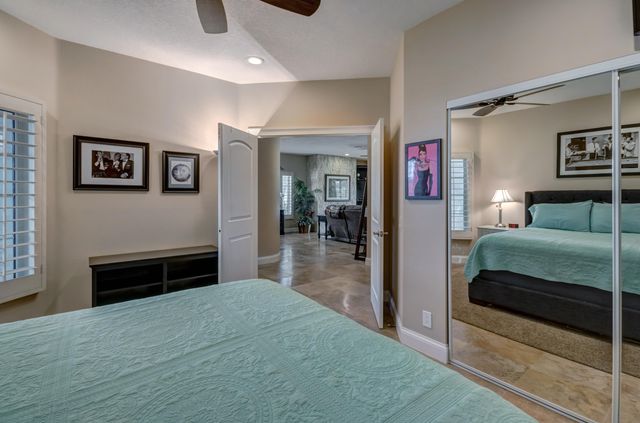 a bedroom with a bed and a television