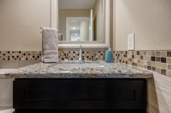 a view of a bedroom with furniture and book shelf