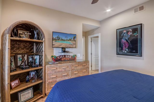 a view of a bedroom with furniture and book shelf
