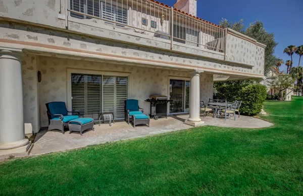 a view of a swimming pool with outdoor seating