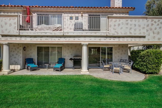 a view of a house with backyard sitting area and garden
