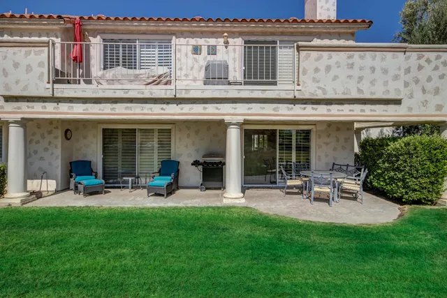 a view of a house with backyard sitting area and garden