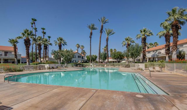 a view of a swimming pool with outdoor seating