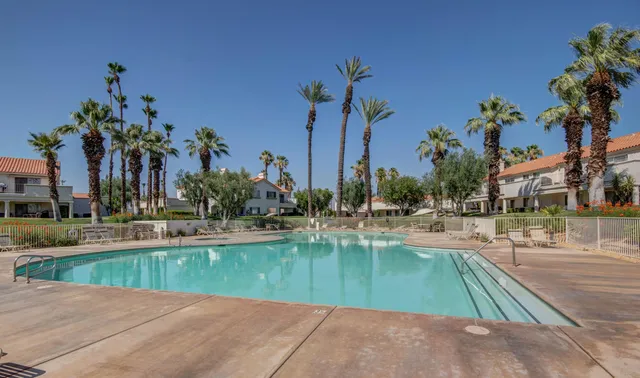 a view of a swimming pool with outdoor seating