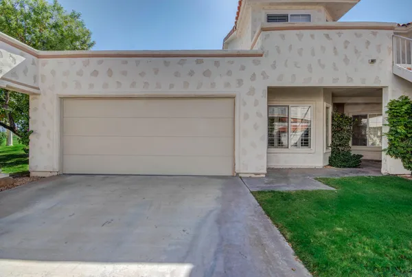 front view of a house with a plants and a window
