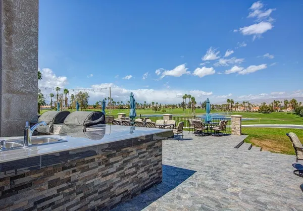 a view of a chair and tables in the patio