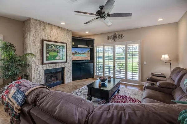 a living room with furniture ceiling fan and a rug