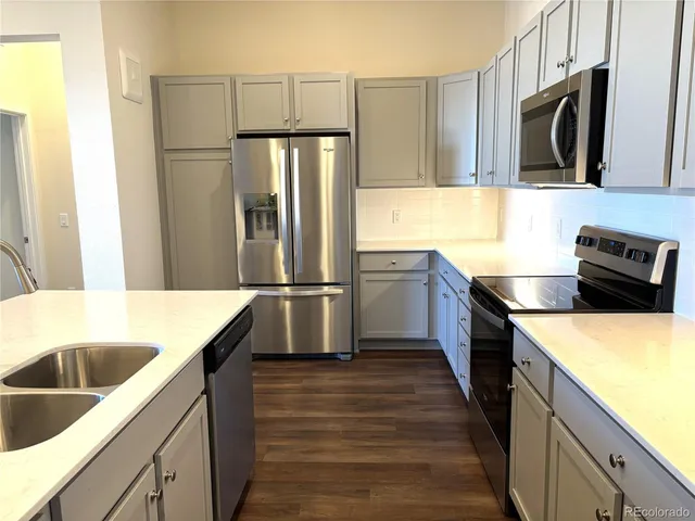 a kitchen with a refrigerator and a sink