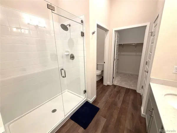 a bathroom with a glass shower door